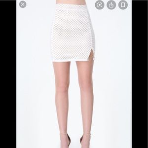 Bebe White Perforated mini skirt w/slit. Size 2P.